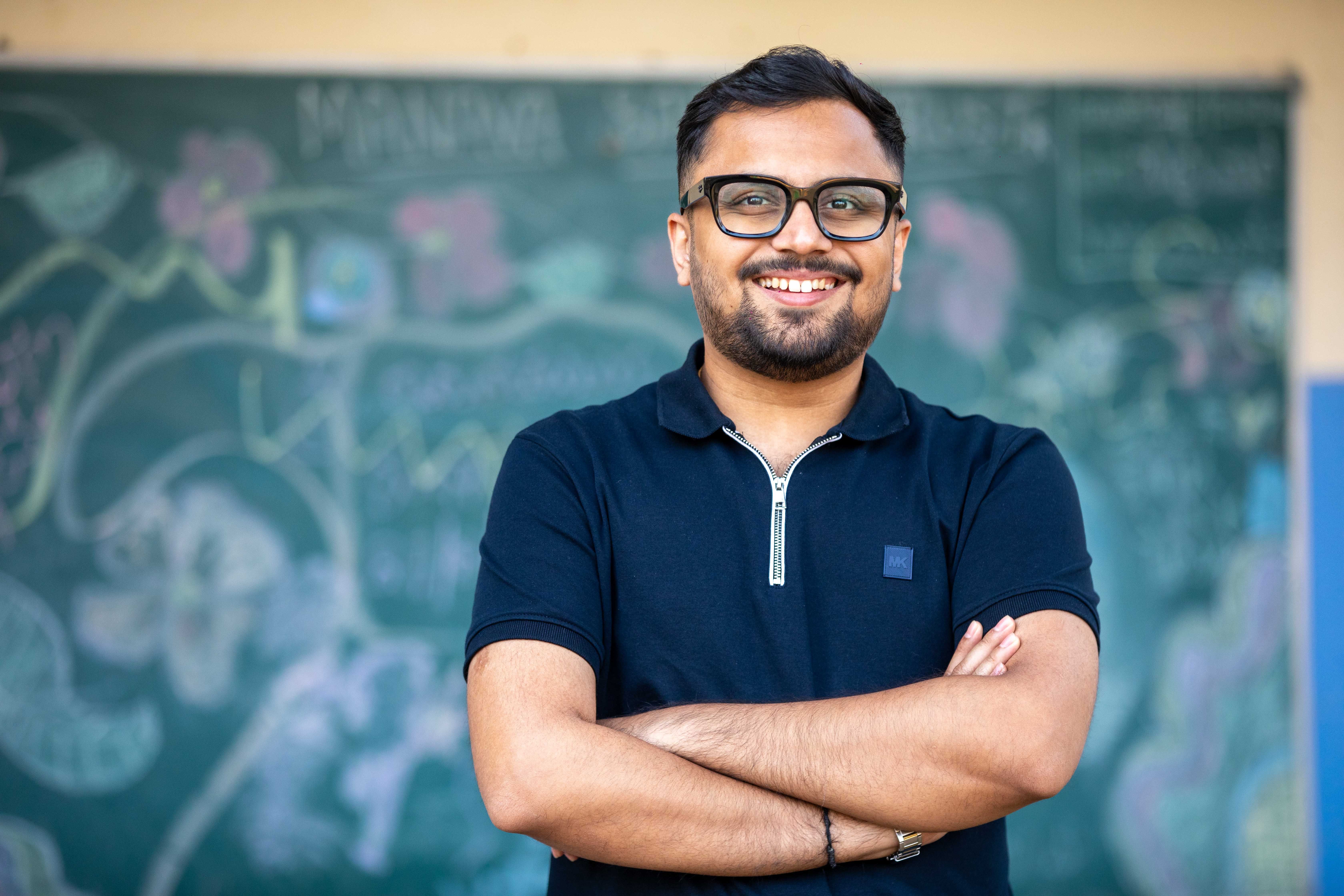 A teacher standing in front of a chalkboard
